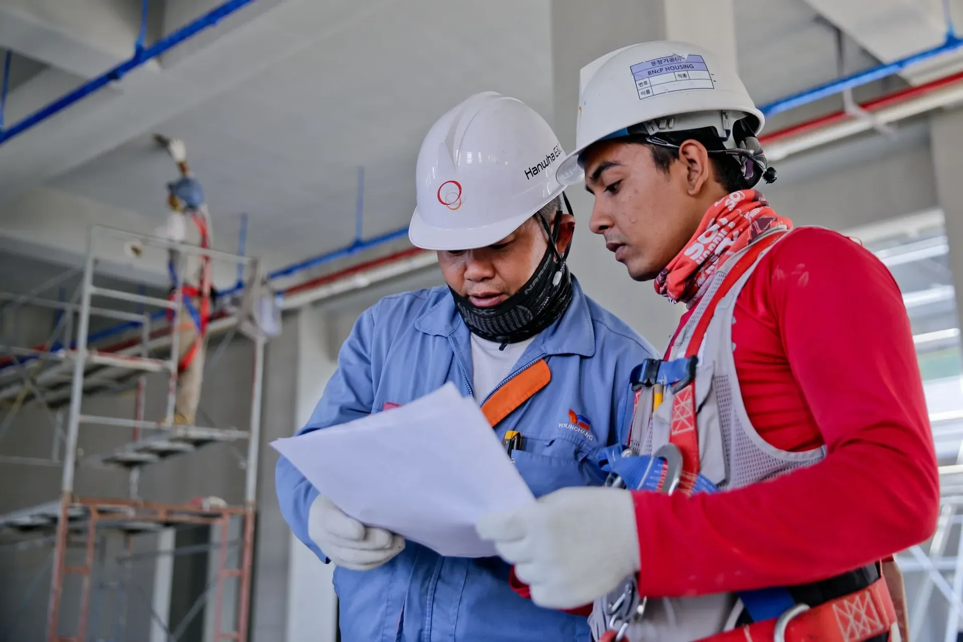 Site engineers reviewing drawings during installation works